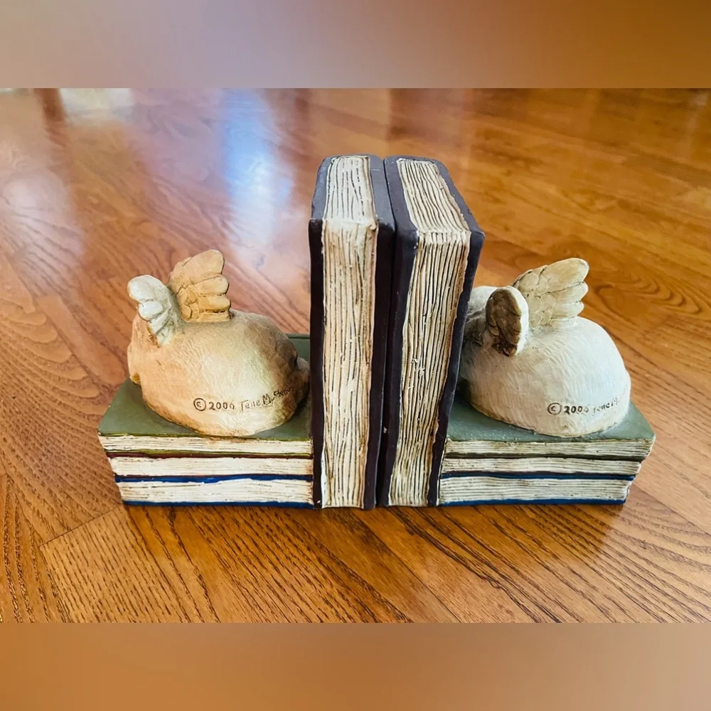 A pair of  stone bunny inc.2006 Telle M. Stein, Dog angel with ball bookends